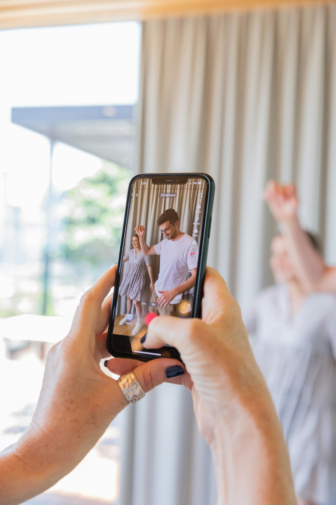 a-person-taking-a-picture-of-a-man-and-woman-8ihr5aunsko